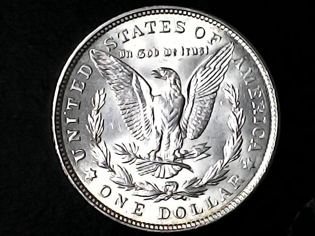 Silver Dollar with an eagle design and 'In God We Trust' inscription on a black background