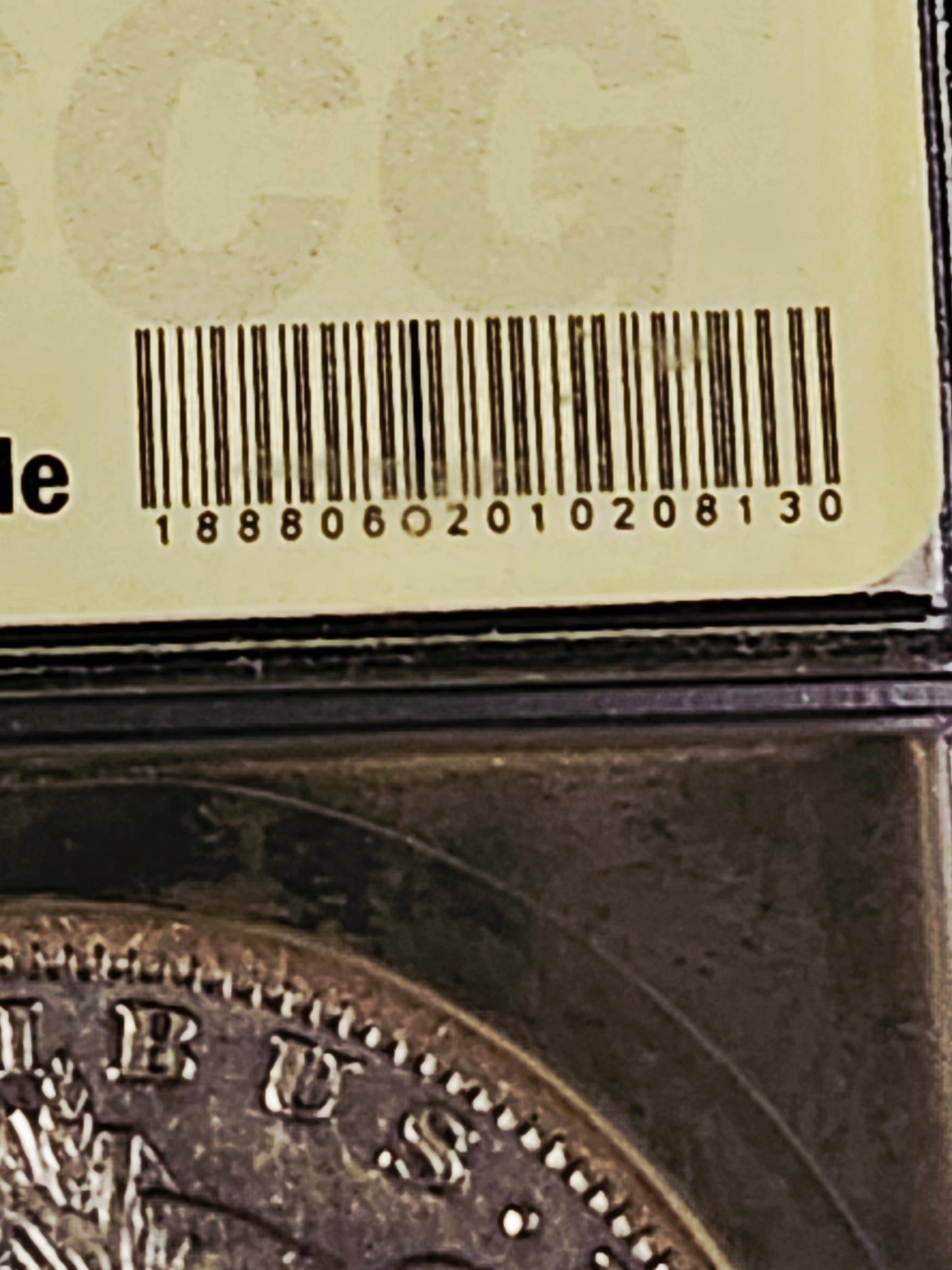 Close-up of a coin with a bar code label 'Hot Lips' Morgan Silver Dollar coin in a USCG certified protective case