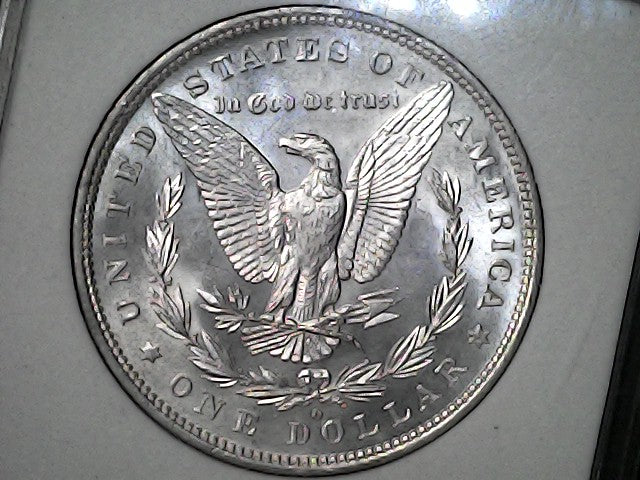 Silver Dollar with an eagle design, 'In God We Trust' and with "O/S" inscription on a black background