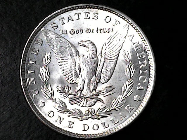 Silver Dollar coin with an eagle design on a black background