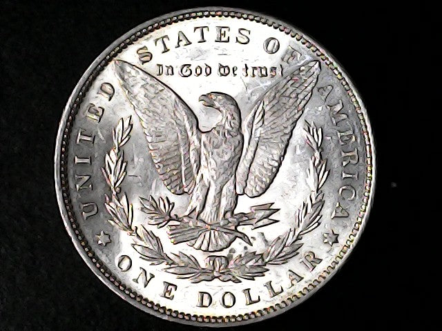 Silver Dollar with an eagle design and 'In God We Trust' inscription on a black background