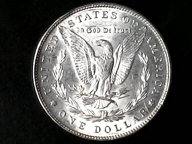 Silver Dollar with an eagle design and 'In God We Trust' inscription on a black background