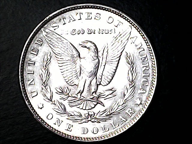 Silver Dollar with an eagle design and 'O' Inscription on a dark background