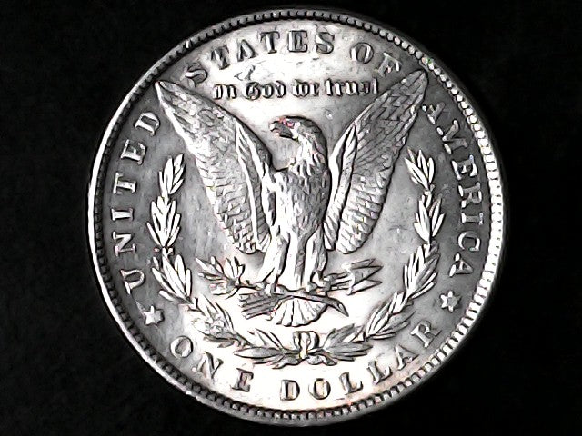 Silver Dollar with an eagle design and 'In God We Trust' inscription on a black background