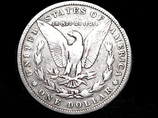 Silver Dollar with an eagle design and 'In God We Trust' inscription on a black background