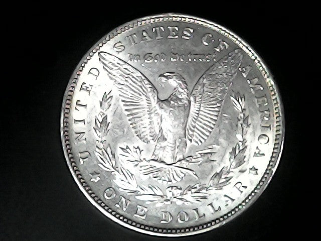 Silver Dollar with an eagle design and 'In God We Trust' inscription on a black background