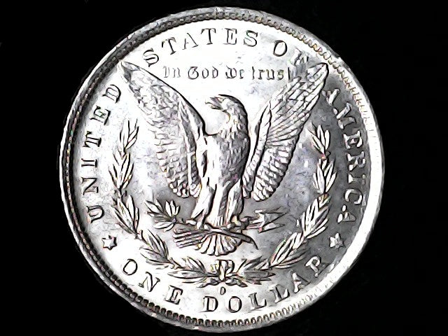 Silver Dollar with an eagle design, 'In God We Trust' and 'O' inscriptions on a black background
