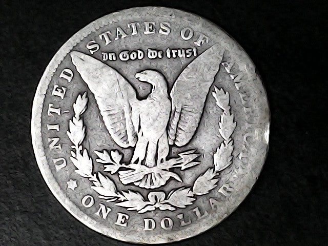 Silver Dollar with an eagle design and 'In God We Trust' inscription on a black background
