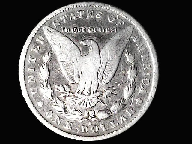 Silver Dollar with an eagle design, 'In God We Trust' and 'S' inscriptions on a black background