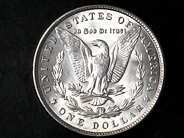 Silver Dollar with an eagle design and 'In God We Trust' inscription on a black background