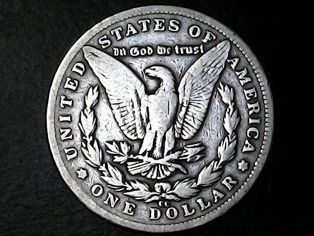 Silver Dollar with an eagle design with "CC" inscription on a black background