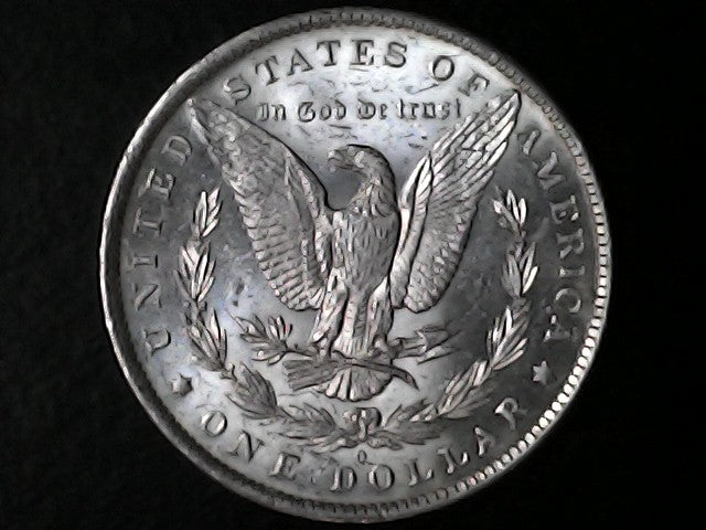 Silver Dollar with an eagle design, 'In God We Trust' and 'O' inscriptions on a black background