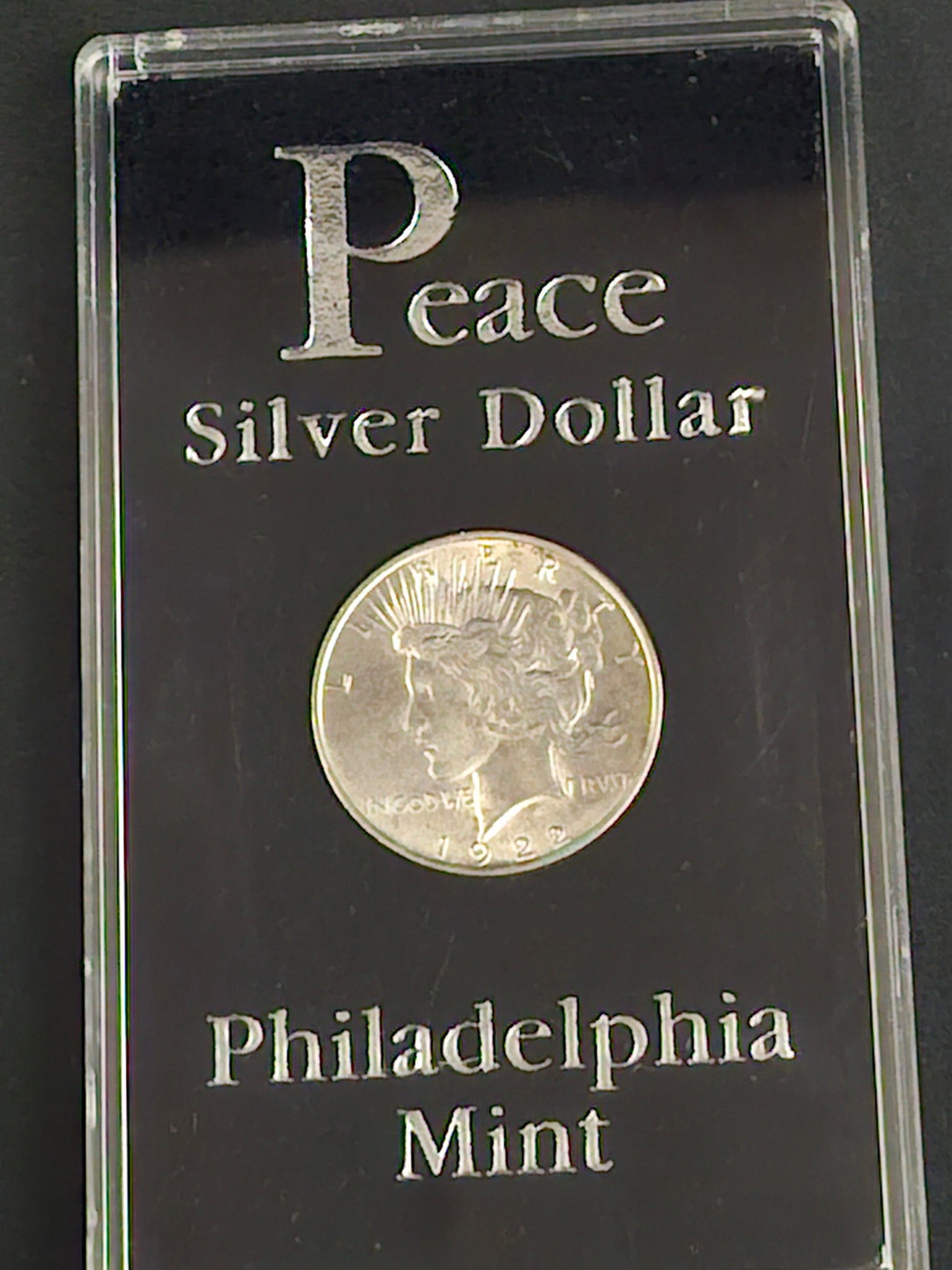 Peace Silver Dollar coin in a Philadelphia Mint display case 