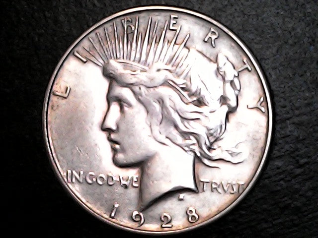 1928 silver Peace dollar with 'Liberty' and 'In God We Trust' inscriptions