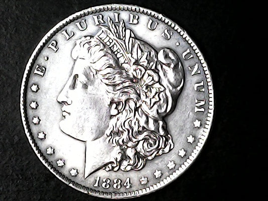 Silver Morgan Dollar Left-facing profile of Liberty wearing a Phrygian cap, with 'LIBERTY', "E PLURIBUS UNUM" and '1884' inscriptions on a black background with case