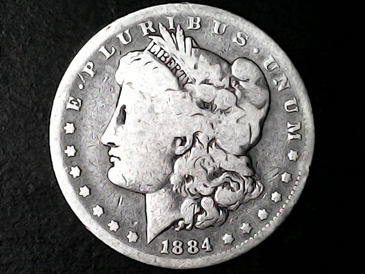 Silver Morgan dollar coin from 1884 with 'E Pluribus Unum' and 'Liberty' inscriptions on a dark background.