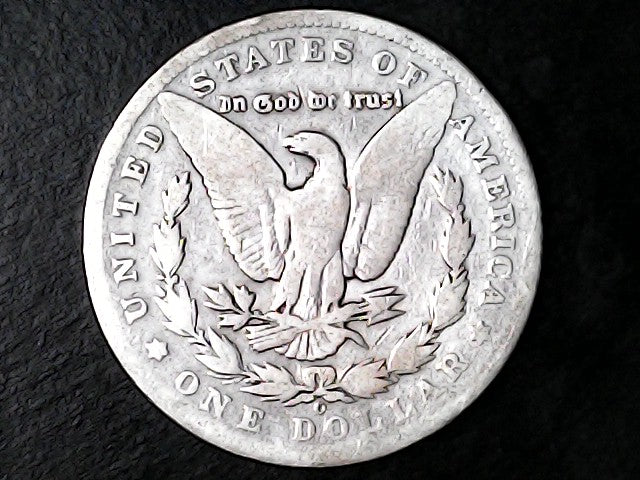 Silver Dollar with an eagle design, 'In God We Trust' and 'O' inscriptions on a black background 