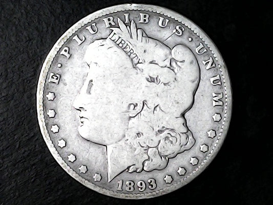 Silver Morgan Dollar Left-facing profile of Liberty wearing a Phrygian cap, with 'LIBERTY', "E PLURIBUS UNUM" and '1893' inscriptions on a black background with case