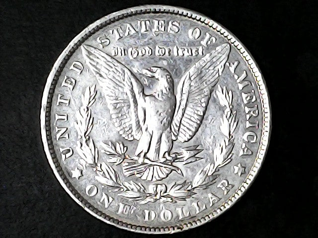 Silver Dollar with an eagle design and 'In God We Trust' inscription on a black background