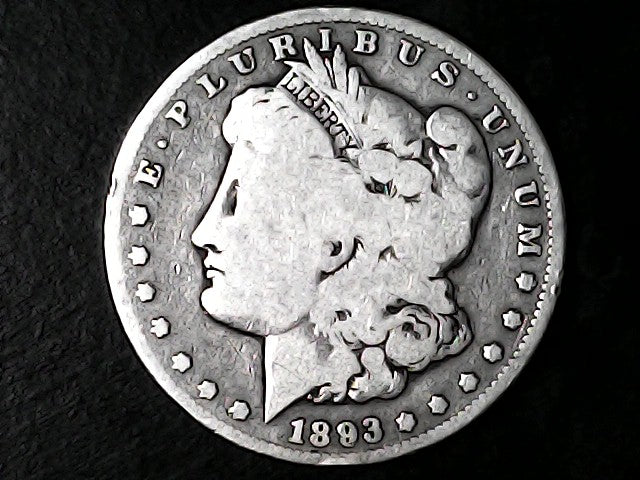Silver Morgan Dollar Left-facing profile of Liberty wearing a Phrygian cap, with 'LIBERTY', "E PLURIBUS UNUM" and '1893' inscriptions on a black background with case