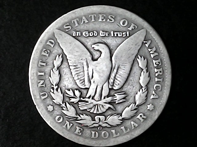 Silver Dollar with an eagle design, 'In God We Trust' and 'O' inscriptions on a black background 