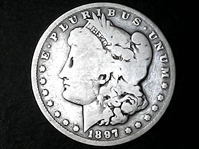 Silver Morgan Dollar Left-facing profile of Liberty wearing a Phrygian cap, with 'LIBERTY', "E PLURIBUS UNUM" and '1897' inscriptions on a black background with case