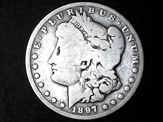 Silver Morgan Dollar Left-facing profile of Liberty wearing a Phrygian cap, with 'LIBERTY', "E PLURIBUS UNUM" and '1897' inscriptions on a black background with case