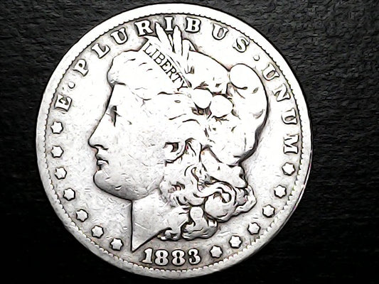 Silver Morgan Dollar Left-facing profile of Liberty wearing a Phrygian cap, with 'LIBERTY', "E PLURIBUS UNUM" and '1883' inscriptions on a black background with case
