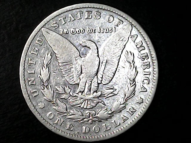caseSilver Dollar with an eagle design and 'S' inscription  on a black background  