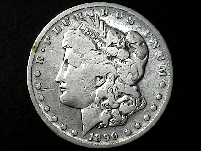 Silver Morgan Dollar with 'E Pluribus Unum', 'Liberty'  and '1890' inscriptions on a black background with 
