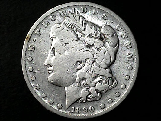 Silver Morgan Dollar with 'E Pluribus Unum', 'Liberty'  and '1890' inscriptions on a black background with 