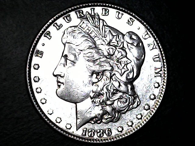 Silver Morgan dollar coin with a profile of Liberty and '1886' inscription on a black background