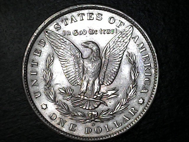 Silver Dollar with an eagle design, 'In God We Trust' and 'O' inscriptions on a black background 