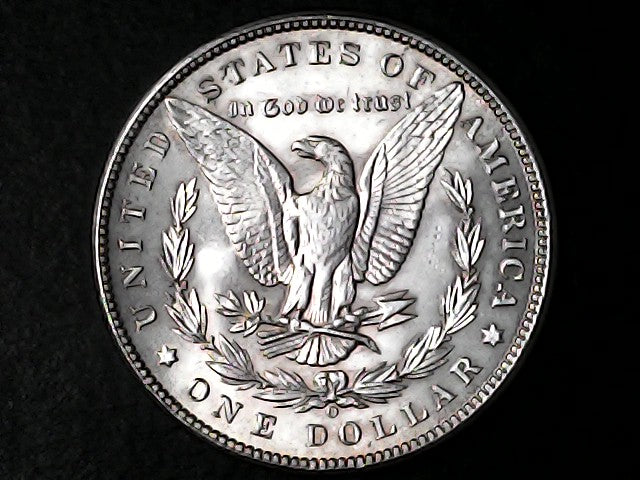 Silver Dollar with an eagle design, 'In God We Trust' and 'O' inscriptions on a black background 