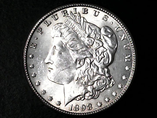 Silver Morgan Dollar Left-facing profile of Liberty wearing a Phrygian cap, with 'LIBERTY', "E PLURIBUS UNUM" and '1898' inscriptions on a black background with case