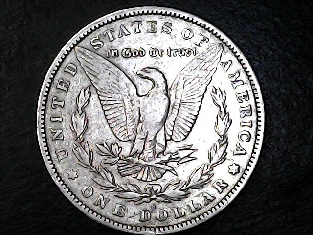 Silver Dollar with an eagle design, 'In God We Trust' and 'S' inscriptions on a black background 