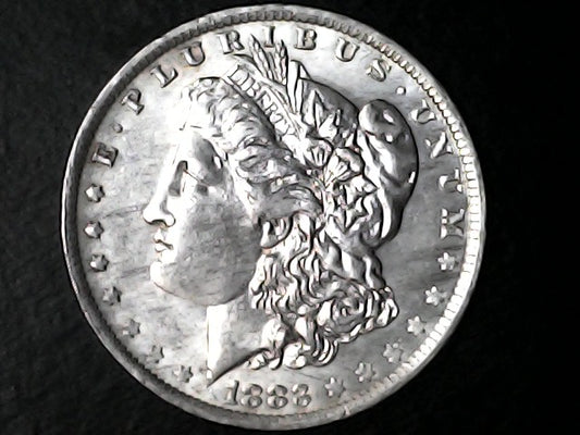 '1883' Silver Morgan Dollar with liberty and inscriptions on a dark background