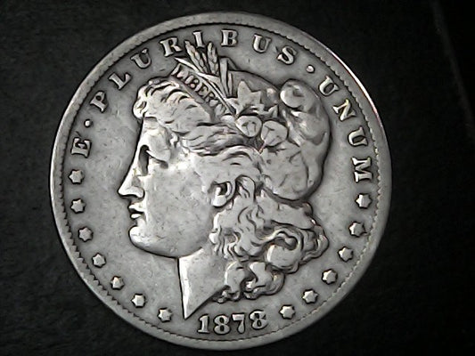 Silver Morgan Dollar Left-facing profile of Liberty wearing a Phrygian cap, with 'LIBERTY', "E PLURIBUS UNUM" and '1878' inscriptions on a black background with case