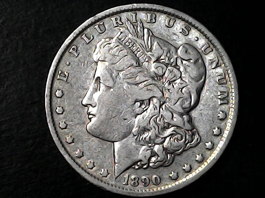 '1890' Silver Morgan dollar coin with Liberty head on a black background