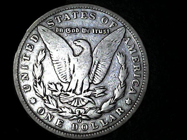 Silver Dollar with an eagle design, 'In God We Trust' and 'O' inscriptions on a black background 