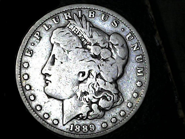 Silver Morgan Dollar Left-facing profile of Liberty wearing a Phrygian cap, with 'LIBERTY', "E PLURIBUS UNUM" and '1889' inscriptions on a black background with case