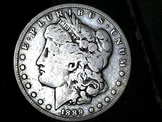 Silver Morgan Dollar Left-facing profile of Liberty wearing a Phrygian cap, with 'LIBERTY', "E PLURIBUS UNUM" and '1889' inscriptions on a black background with case