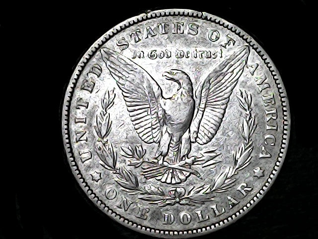 Silver Dollar with an eagle design and 'In God We Trust' inscription on a black background