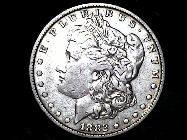 Silver Morgan Dollar Left-facing profile of Liberty wearing a Phrygian cap, with 'LIBERTY', "E PLURIBUS UNUM" and '1882' inscriptions on a black background with case