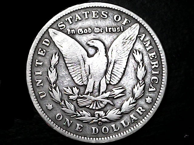 Silver Dollar with an eagle design, 'In God We Trust' and 'O' inscriptions on a black background 