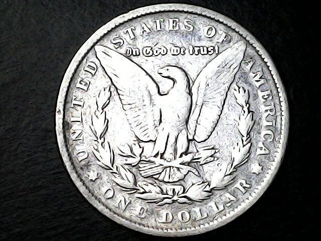 Silver Dollar with an eagle emblem and 'In God We Trust' on a dark background