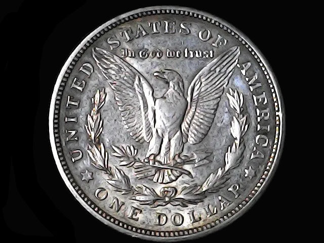 Silver Dollar with an eagle design and 'In God We Trust' and 'D' inscription on a black background