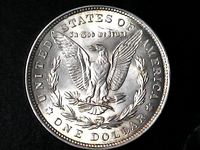 Silver Dollar with an eagle design and 'In God We Trust' inscription on a black background