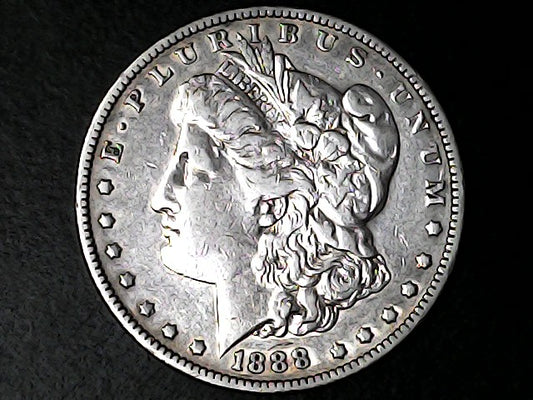 '1888' Silver Morgan Dollar with a profile of a head and 'E Pluribus Unum' inscription on a dark background