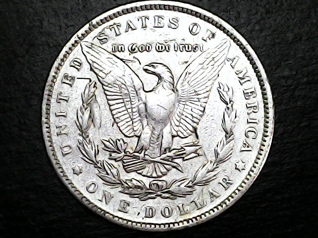 Silver Dollar with an eagle design and 'In God We Trust' inscription on a black background